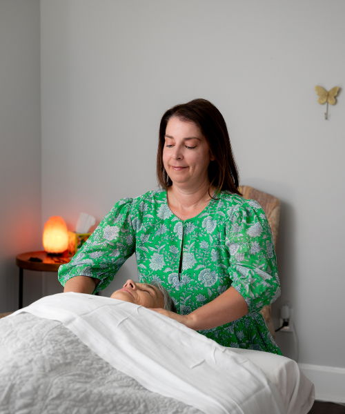 Calm and Restore Upper Body Treatment jackie massaging a client's shoulders