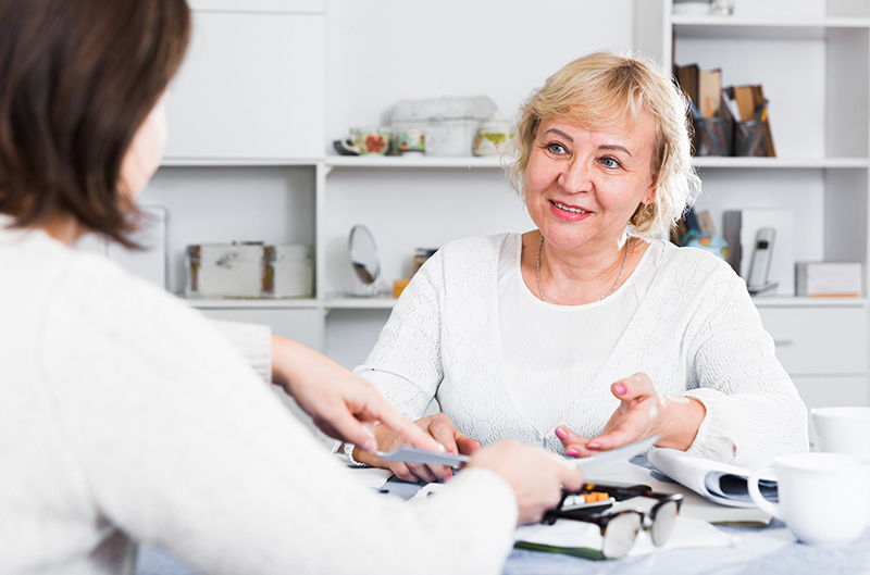 elderly woman meeting with other woman