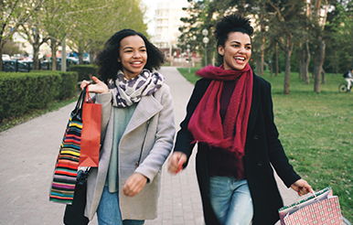 Holiday Budget Sisters walking with shopping bags