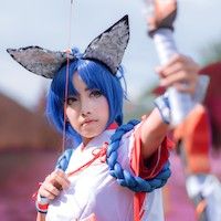 woman in blue wig and fox ears drawing a bow