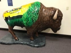 life size bison with green and yellow paint