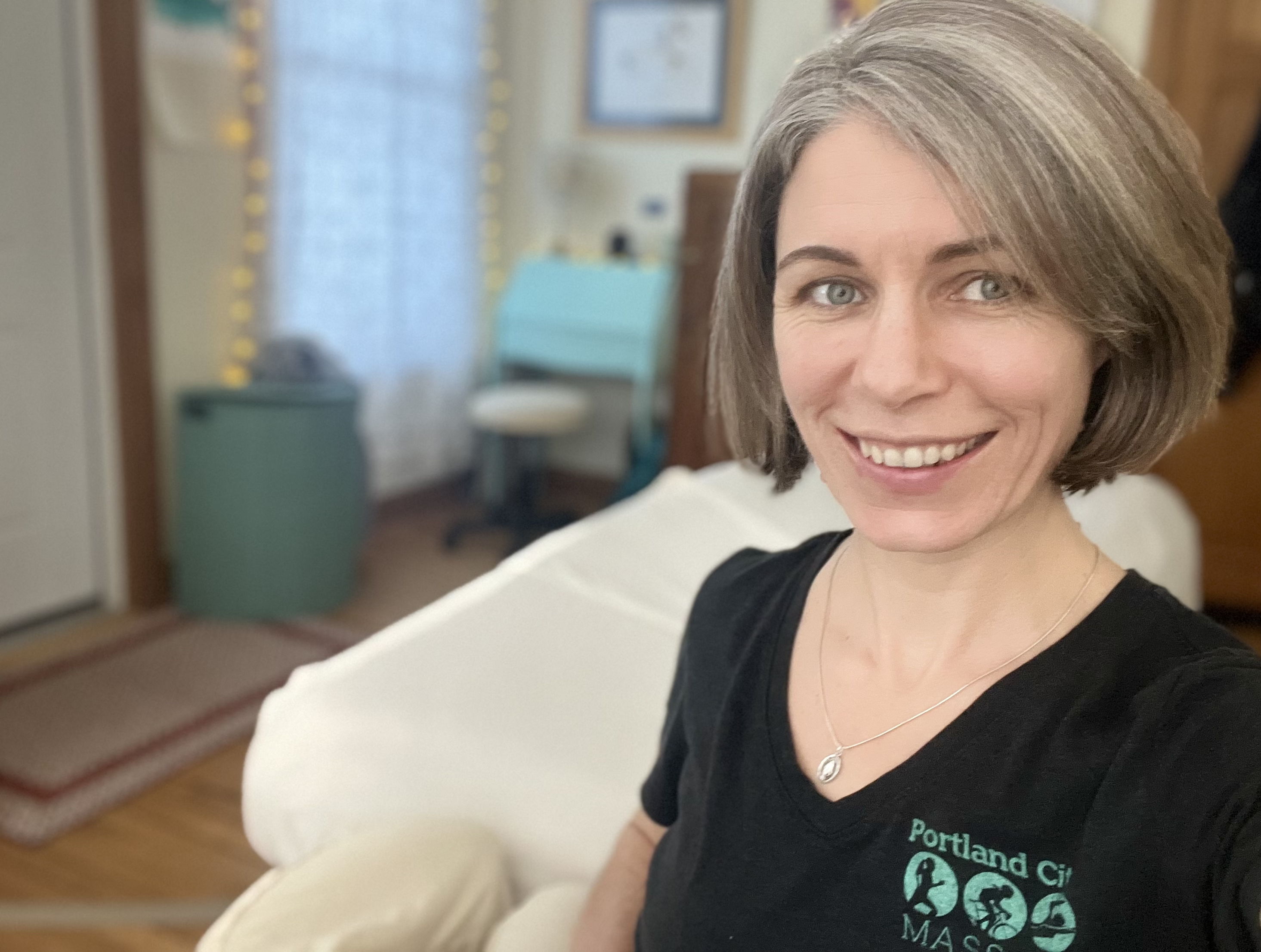 Head shot of woman smiling in massage office