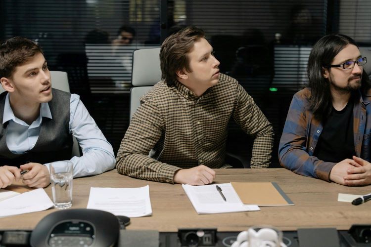 Young men in conference room Young men in conference room