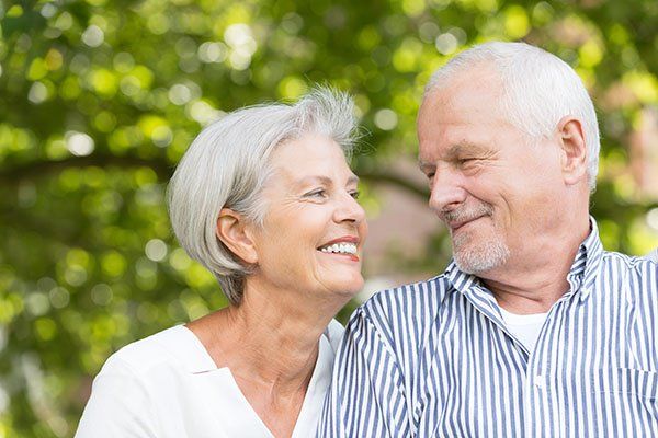 elderly couple looking at each other and smiling