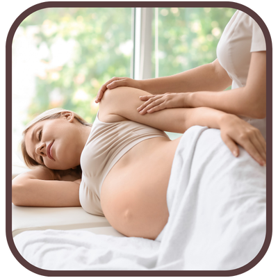 prenatal & postnatal massage woman with pregnant belly receiving massage