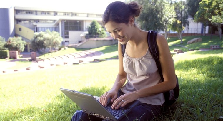 College girl on laptop at school