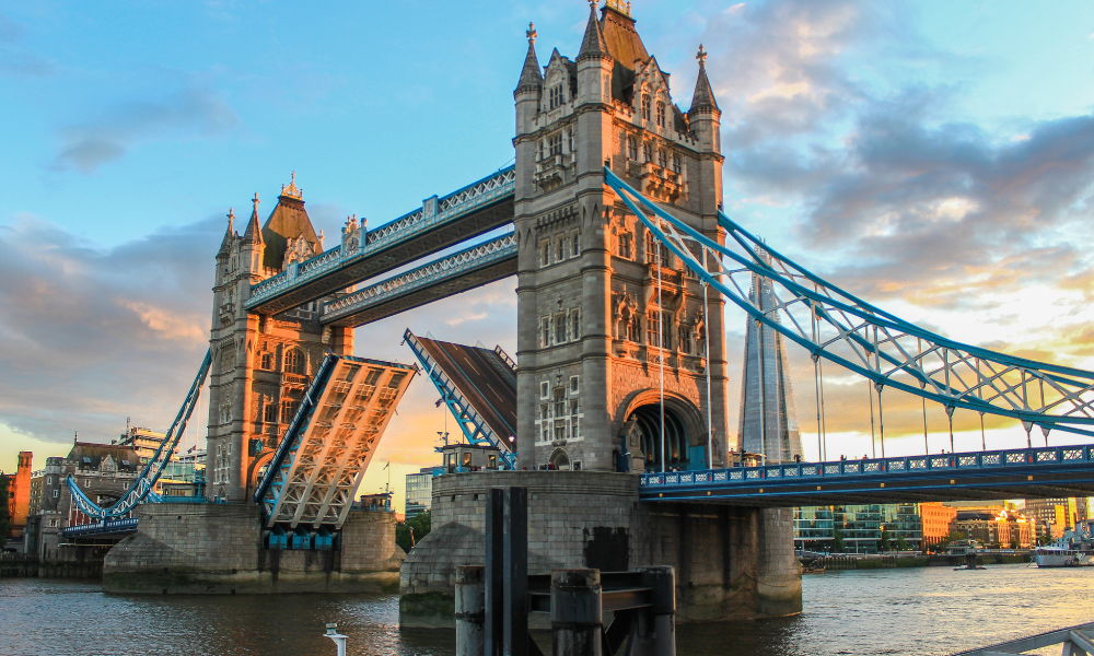 tower bridge can be seen opening at sunrise in London
