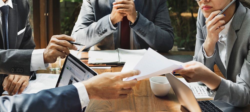 business people passing around documents