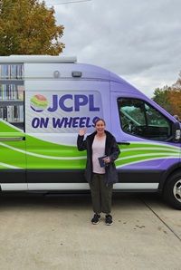 April Windisch in front of JCPL on Wheels bookmobile