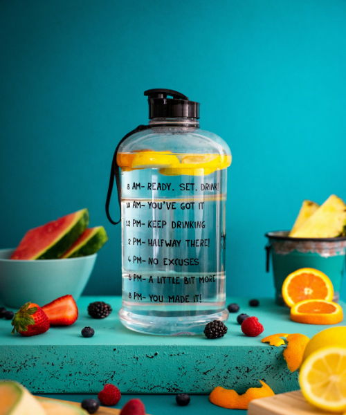 health coaching greenwood nc water bottle surrounded by fresh cut fruit