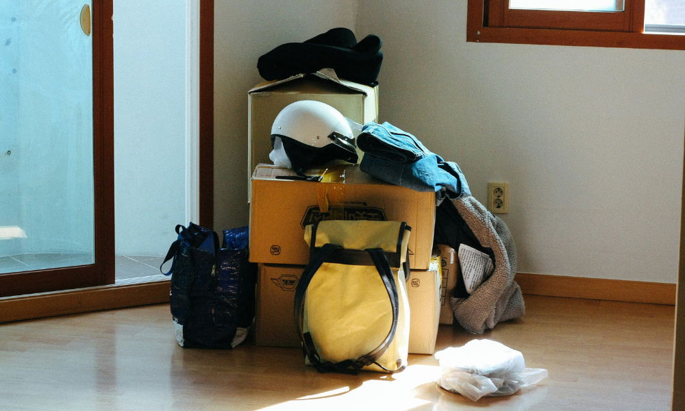 pack up and move boxes and bags filled up and ready to move out of an empty apartment