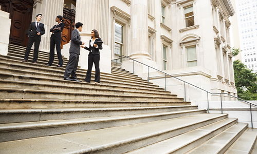 lawyers discussing in front of the courthouse