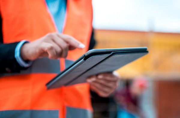 Image of man using an iPad or Tablet on a site