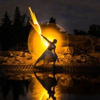 silhouette of a figure holding a bolt of yellow lightning