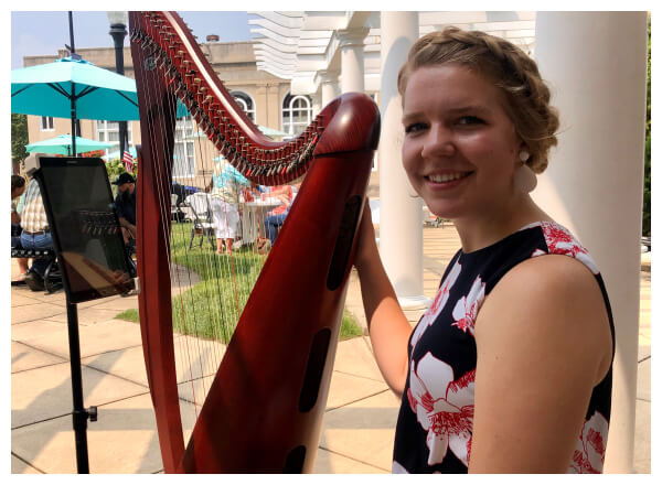 Lady with harp outside