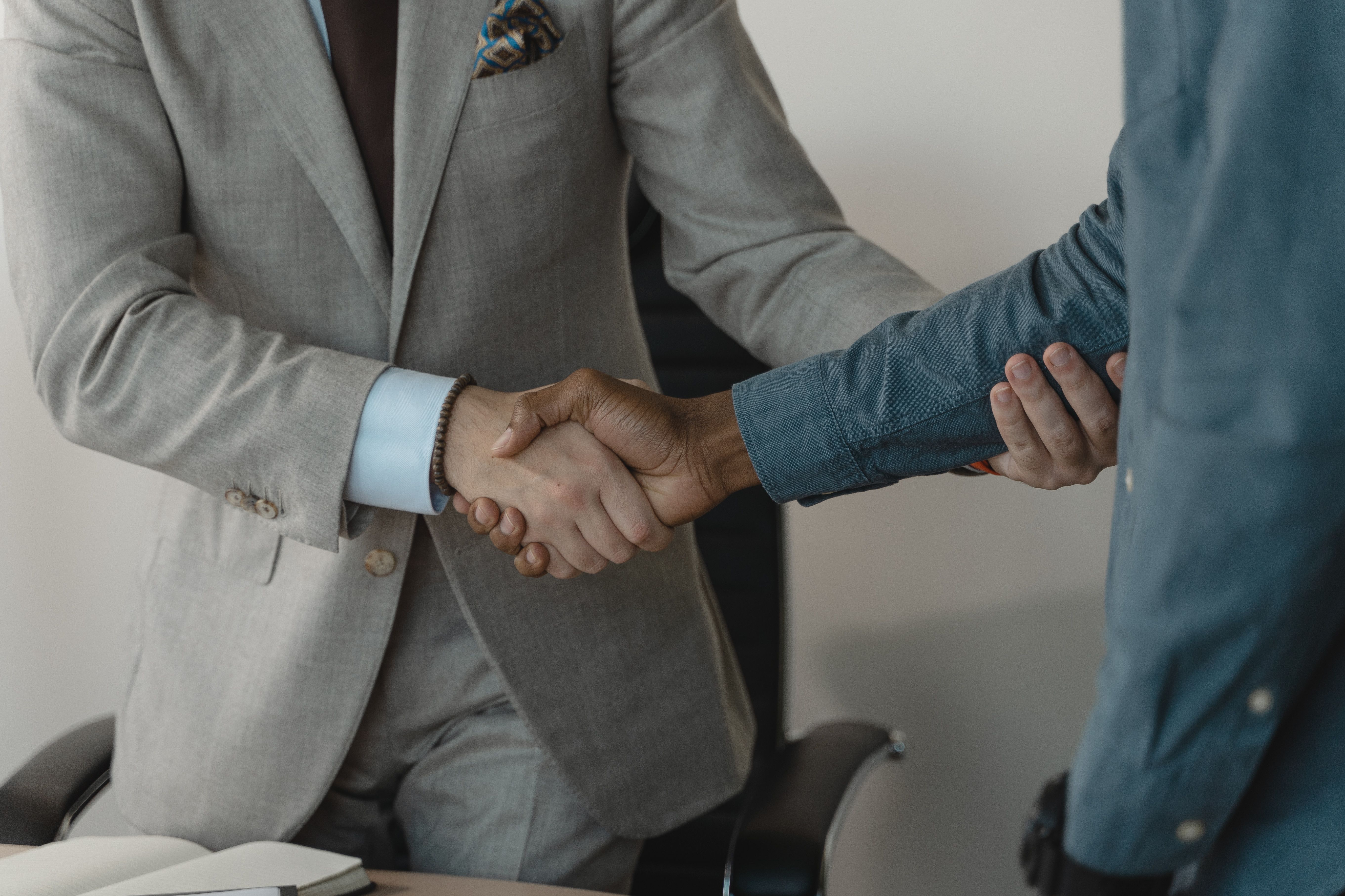 two people in suits shaking hands