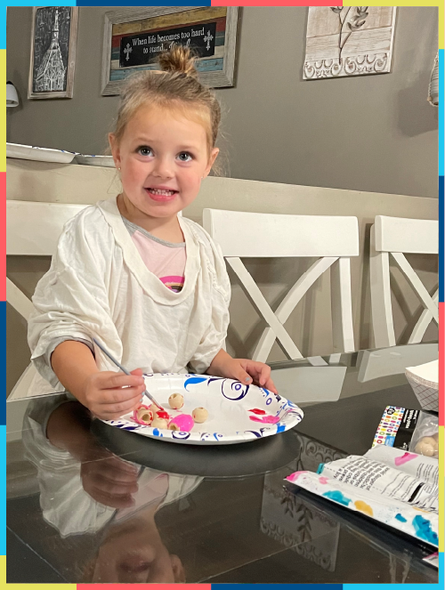 Happy child painting toys