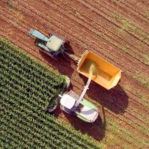 aerial view of a tractor harvesting a fiel