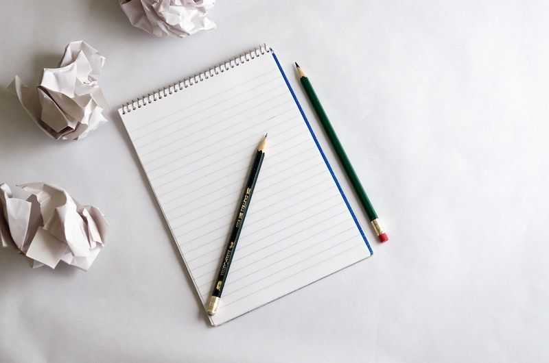 Courtesy of frederick-medina from unsplash Pad of paper with two pencils and crumpled pieces of paper