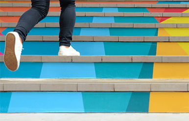 Know the ins and outs of the lending process, Walking up colorful steps.