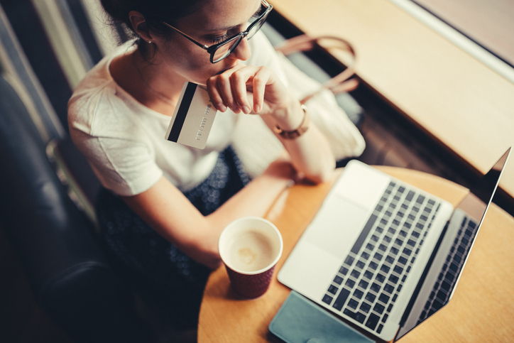 Woman thinking about spending money online