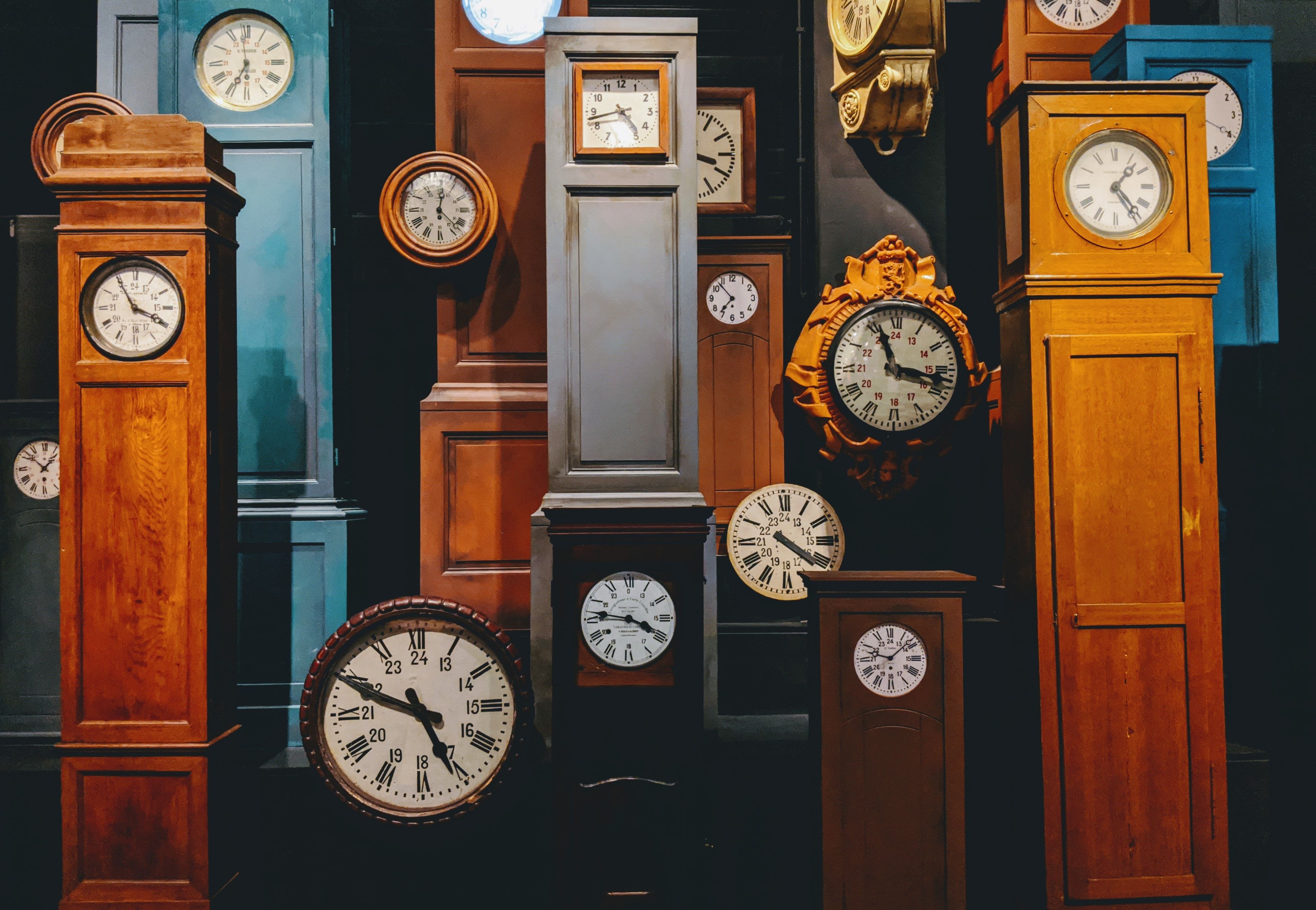 Courtesy of lucian-alexe from unsplash A full picture of different heights and styles of grandfather clocks.