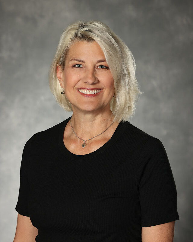 headshot of Sandra Oshiro, blonde woman in black shirt