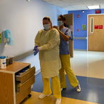 two masked massage therapists in a hospital