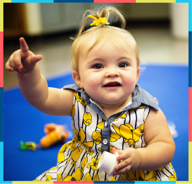 Happy baby in yellow dress