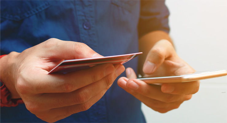 Man holding phone and credit card