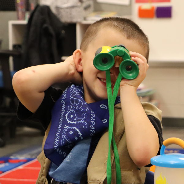 Adventurous child using binoculars