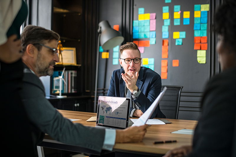 man discussing business with team