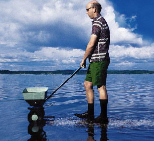 Image of man using fertilizer in water Image of man using fertilizer in water
