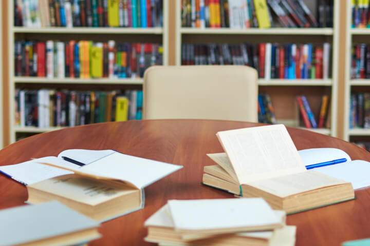 Table in library with open books