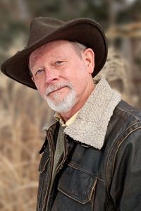 author William Kent Krueger in brown cowboy hat