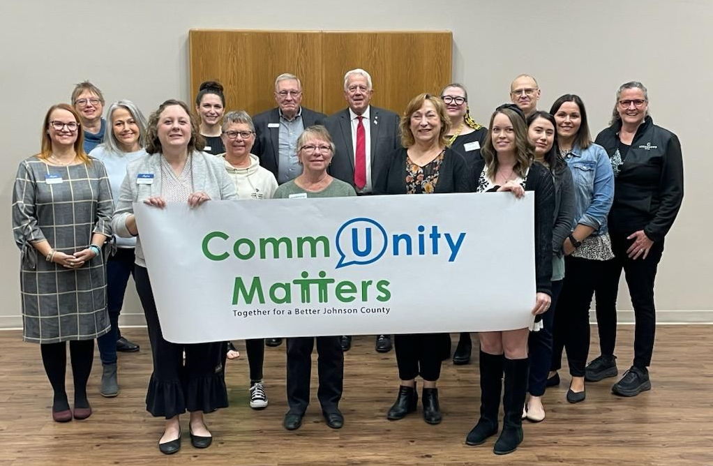 Community Matters team holding sign with new logo