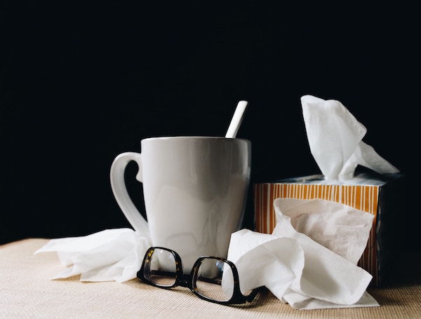 tissues, cup of tea, eyeglasses