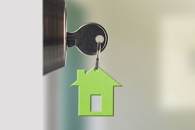 Mortgage Loans Image of house key in lock