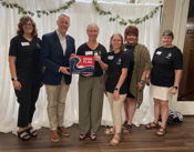 Goode presents flag to Alpha Omega Chapter of Delta Theta Tau