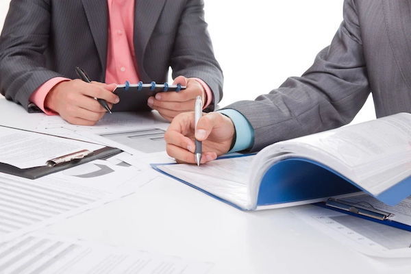 businessmen-working-with-pads-on-the-desk.jpeg