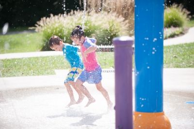 kids playing at water park splash pad