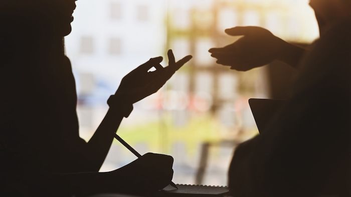 silhouetted conversation between man and woman