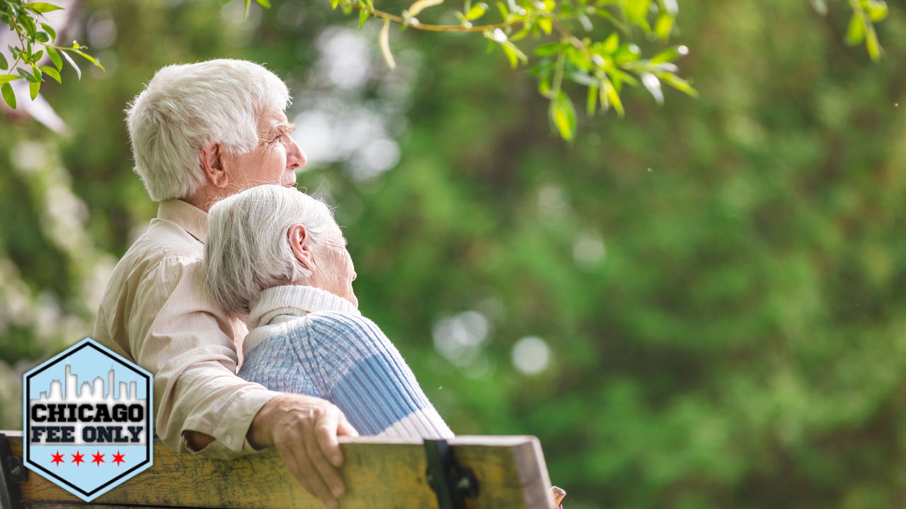 older couple on park bench gazing into distance