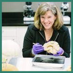 Headshot of Lauren Fowler holding a brain