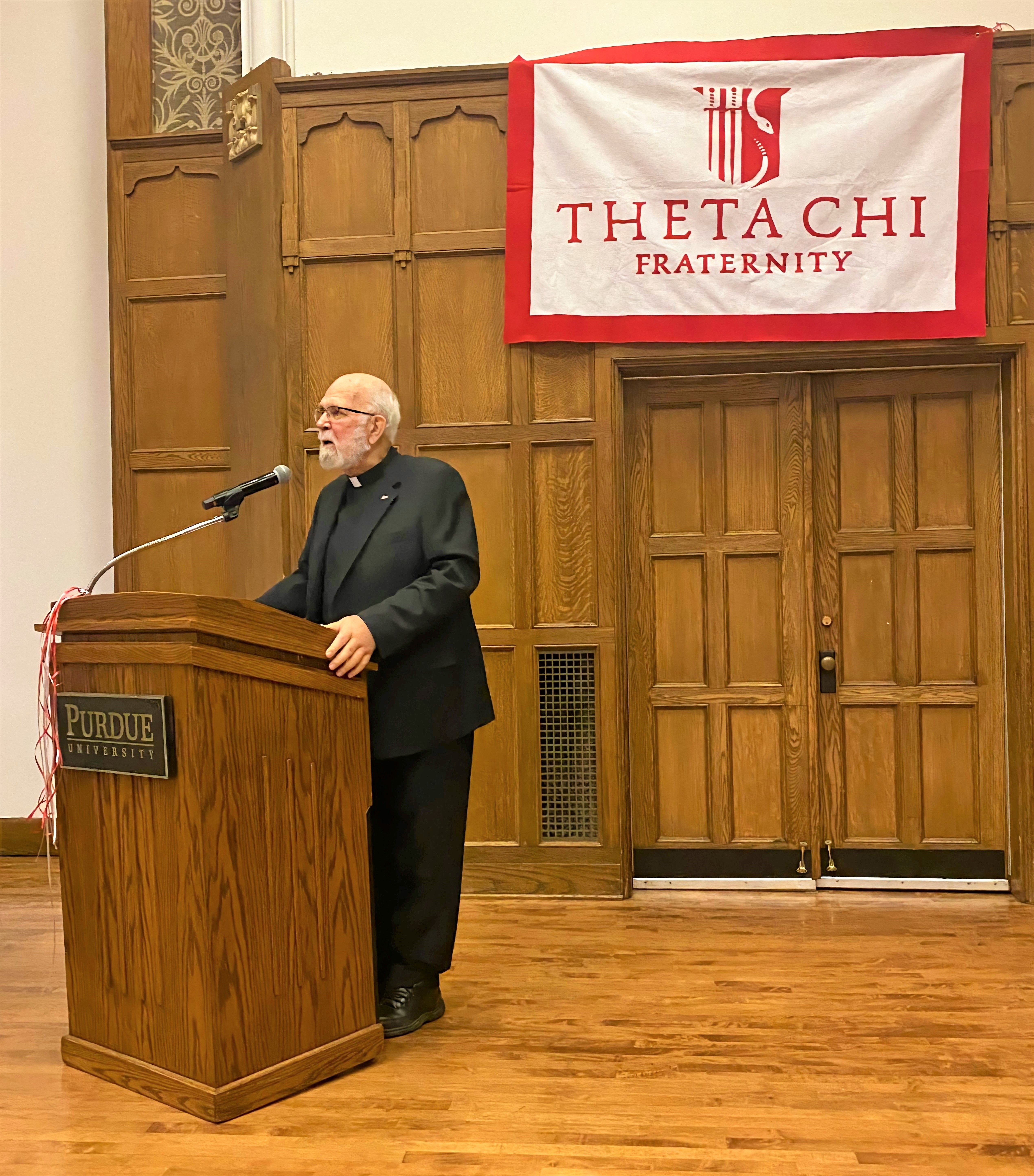 Fr. Phil speaking at a Theta Chi event