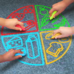 Kids hands drawing with sidewalk chalk Kids hands drawing with sidewalk chalk