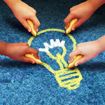 Children hands drawing a lightbulb with sidewalk chalk Children hands drawing a lightbulb with sidewalk chalk