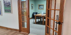 Study Room Study Room 1 is a small space for up to six people with a rectangular wood table and five plastic chairs. The room is green with a wood and glass-framed door. A sign that say “No food or drink” sits on the table.