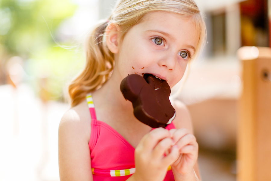 Girl eating Mickey Ice Cream