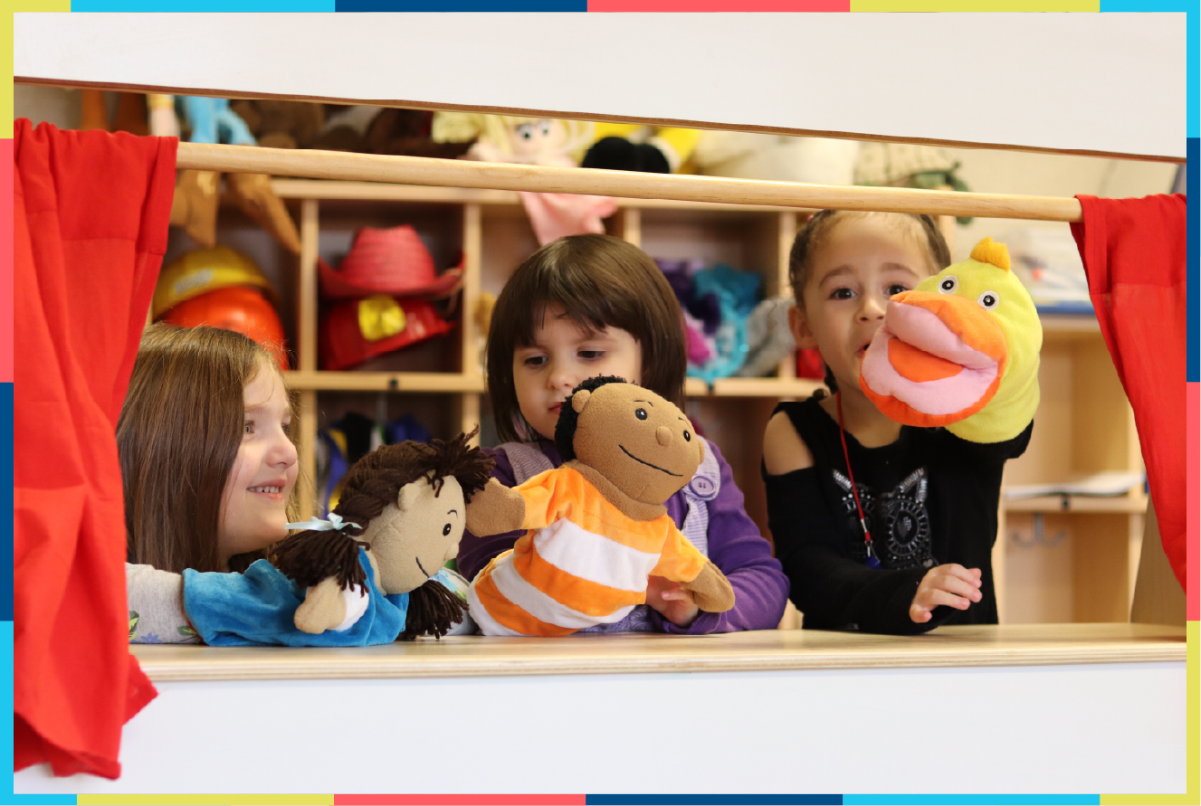 Kids playing in hand puppet theater